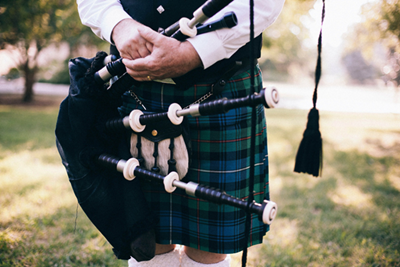 Local Scottish Bagpiper in traditional Kilt