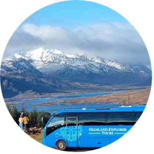 Highland Explorer Tours bus with snowy mountains